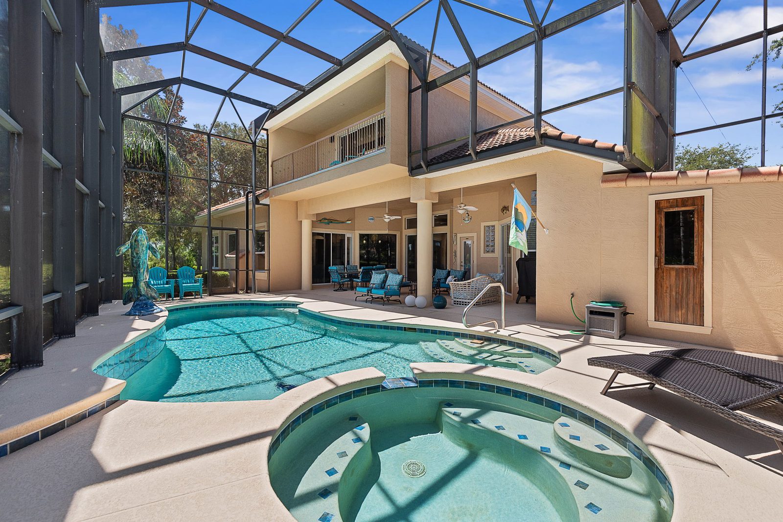 Private heated pool and spa beneath a two-story screened lanai